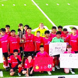 Middle School Boys Soccer team with signs