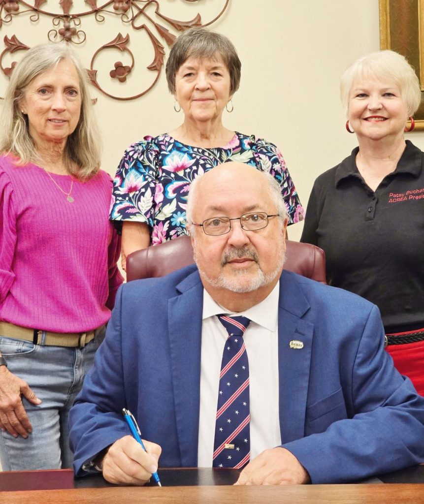 Pictured (l-r): Dawn Melton, Shirley Phillips, and ACREA President Patsy Buchanan look on as Mayor Tim Varnadore signs a Proclamation designating November 2, 2025 as Retired Educators Day in Baxley/Appling County.