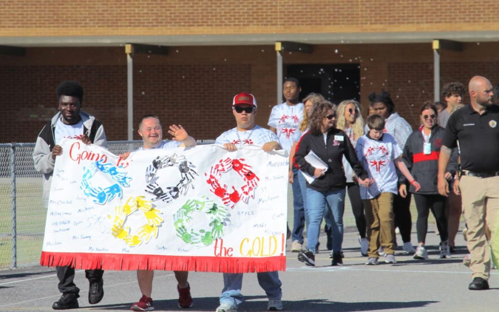 Special Olympics class carrying the DIY banner