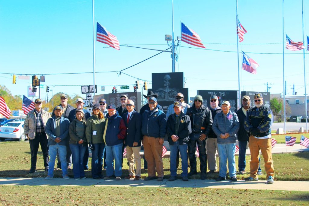 Appling County Veterans standing in front of courthouse memorial